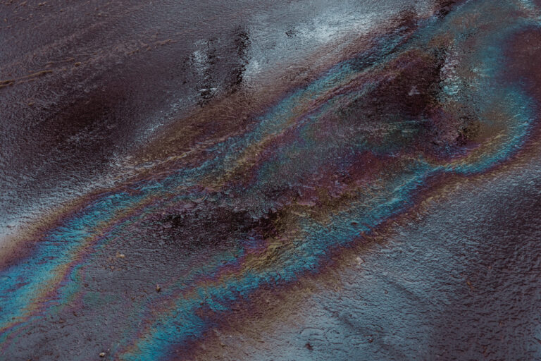 Oil spill on wet asphalt and oil spill absorbents