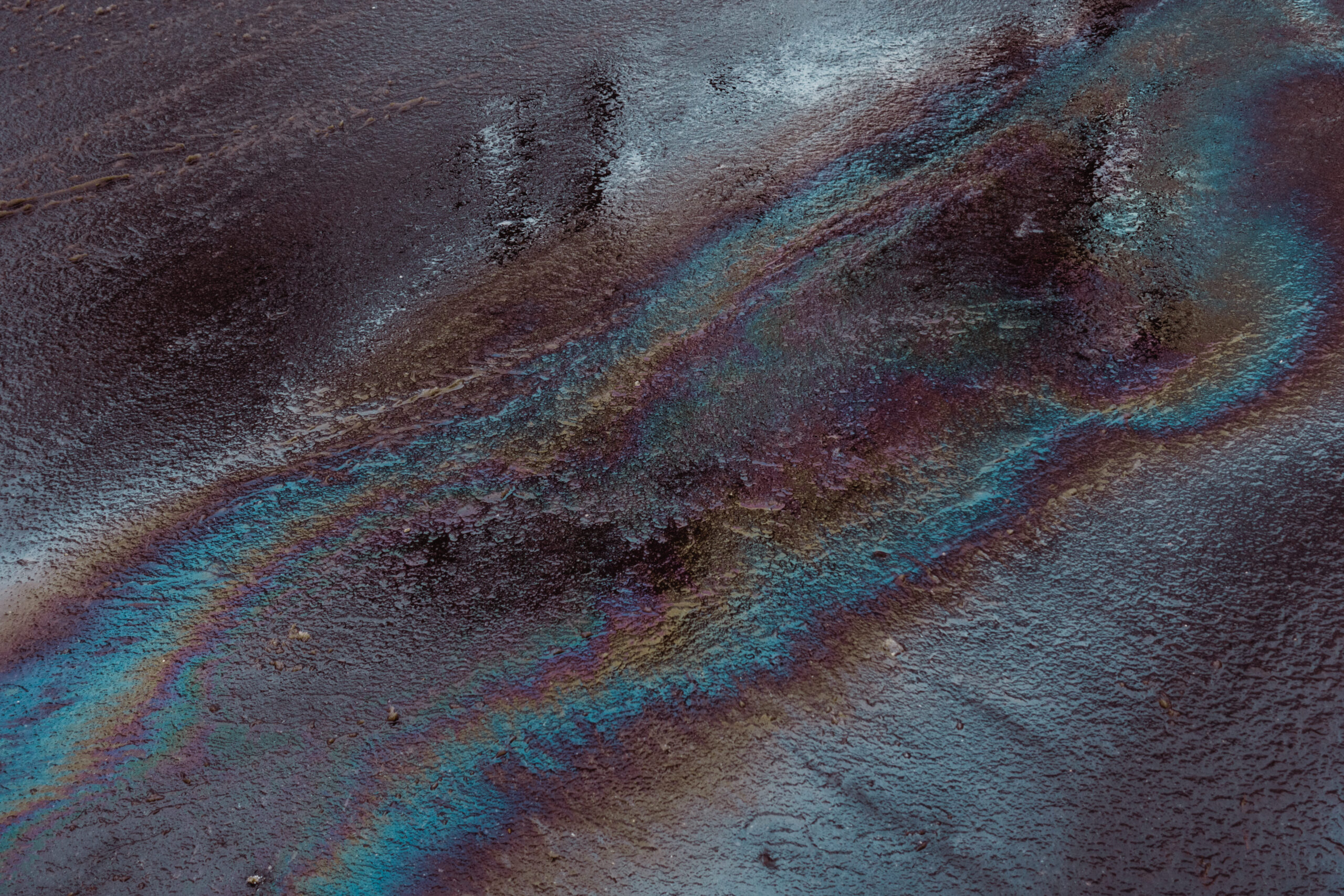 Oil spill on wet asphalt and oil spill absorbents
